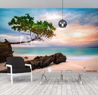 Bild på Exotic seascape with sea grape trees leaning above a rocky Caribbean beach at sunset in Cayo Levantado Dominican Republic